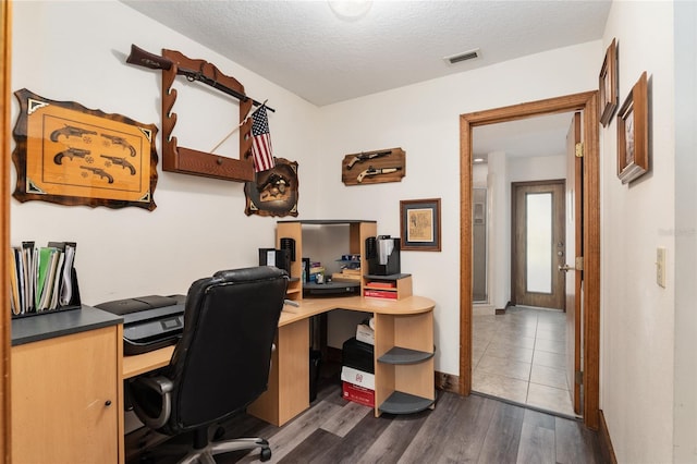 office area featuring dark hardwood / wood-style floors and a textured ceiling