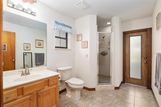 bathroom with vanity, a shower with shower door, tile patterned floors, and toilet