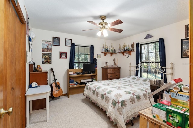 bedroom with light carpet, a textured ceiling, a closet, and ceiling fan