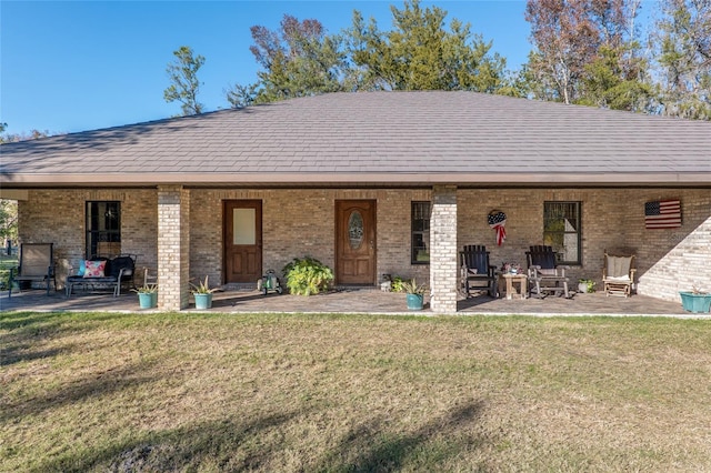 back of house featuring a patio and a lawn