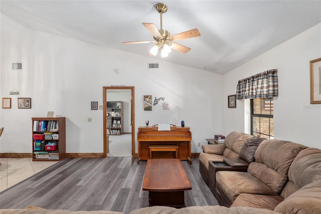 living room with lofted ceiling, hardwood / wood-style floors, and ceiling fan