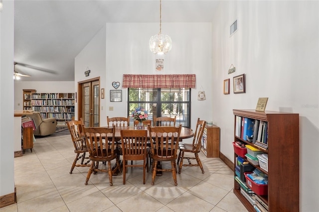 tiled dining area featuring ceiling fan with notable chandelier