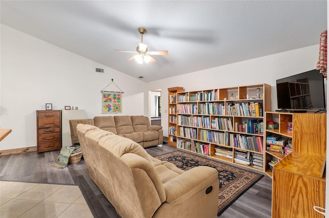 living room featuring ceiling fan, lofted ceiling, and hardwood / wood-style floors