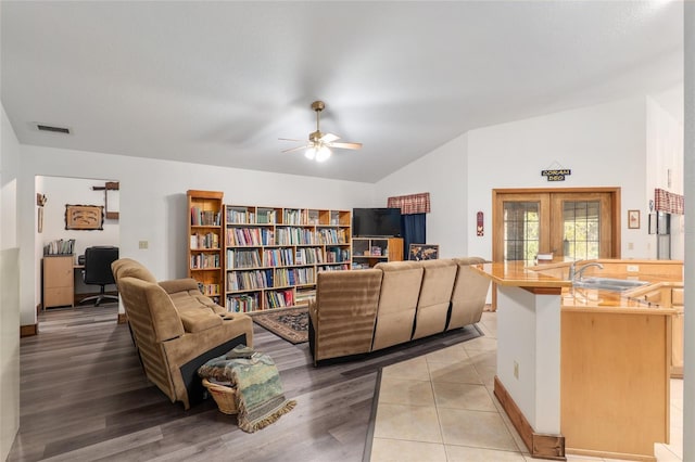 interior space featuring light wood-type flooring, sink, ceiling fan, and french doors