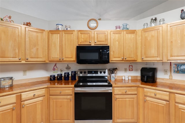 kitchen with wood counters, stainless steel electric stove, and light brown cabinets