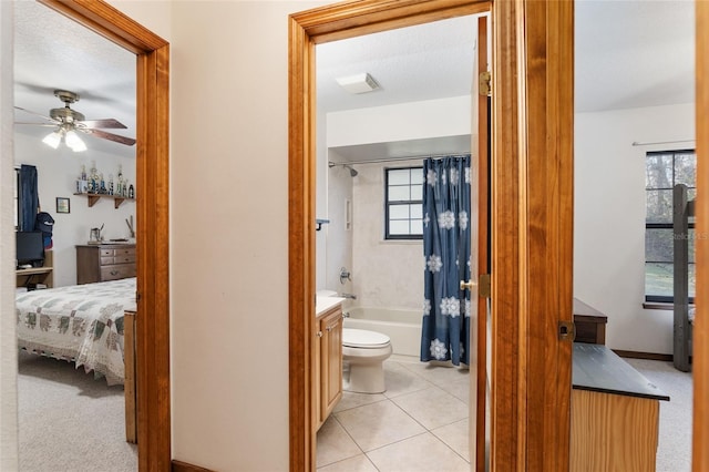 full bathroom with vanity, ceiling fan, toilet, shower / bath combo, and tile patterned floors