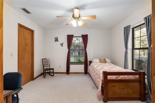 bedroom with light carpet and ceiling fan