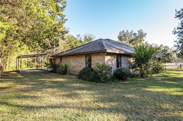 view of home's exterior featuring a carport and a yard