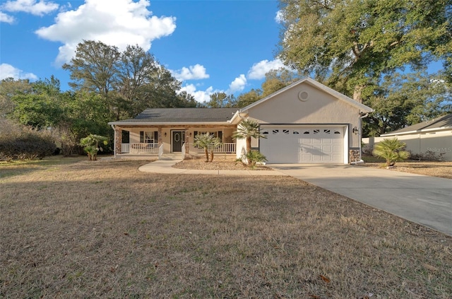 ranch-style house featuring a garage, covered porch, and a front yard