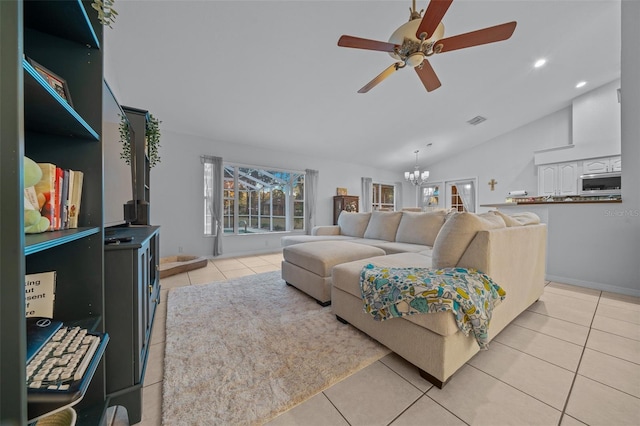 living room featuring light tile patterned flooring, a healthy amount of sunlight, ceiling fan with notable chandelier, and vaulted ceiling