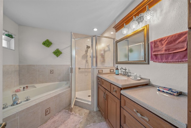 bathroom with vanity and shower with separate bathtub