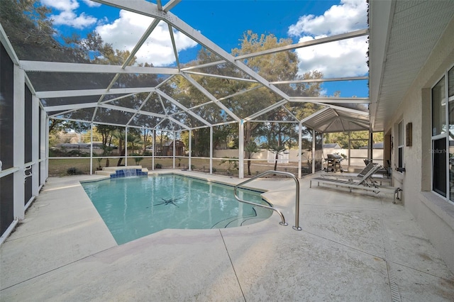 view of pool featuring pool water feature, a patio, and glass enclosure