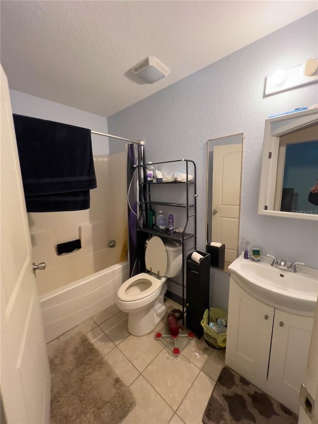 full bathroom with shower / tub combo with curtain, vanity, a textured ceiling, tile patterned floors, and toilet