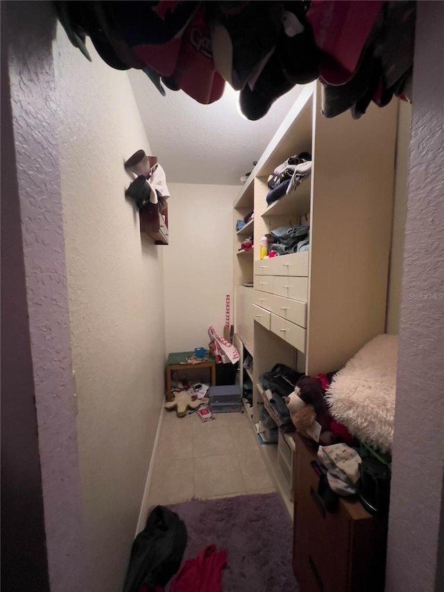 spacious closet featuring tile patterned floors