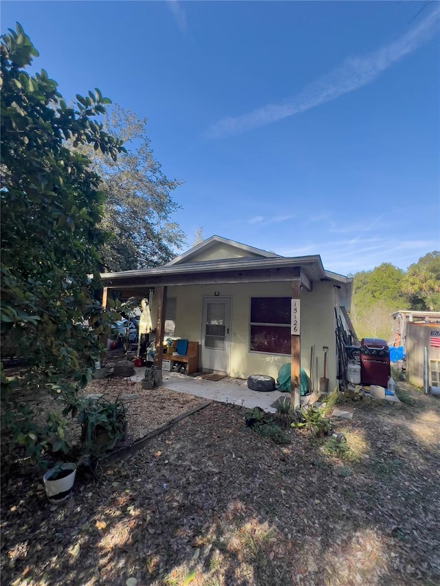 back of house with a patio area