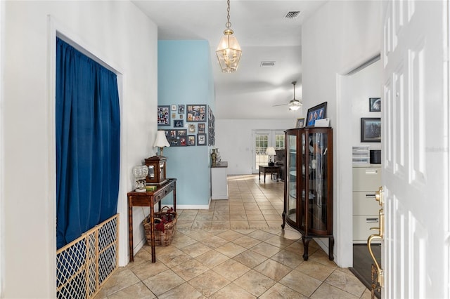 foyer featuring ceiling fan and light tile patterned flooring