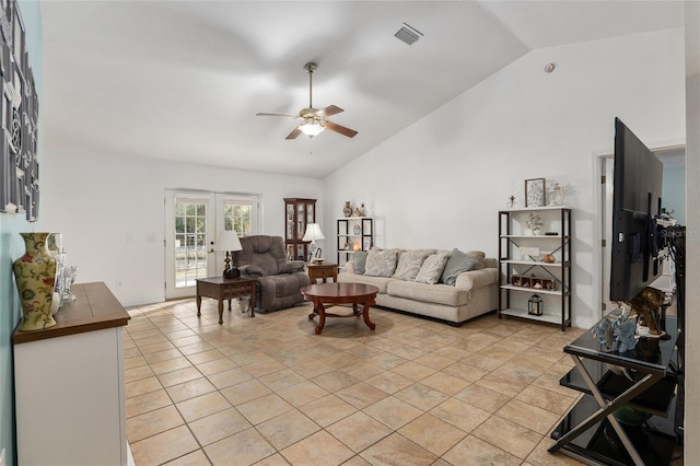 tiled living room with vaulted ceiling, ceiling fan, and french doors