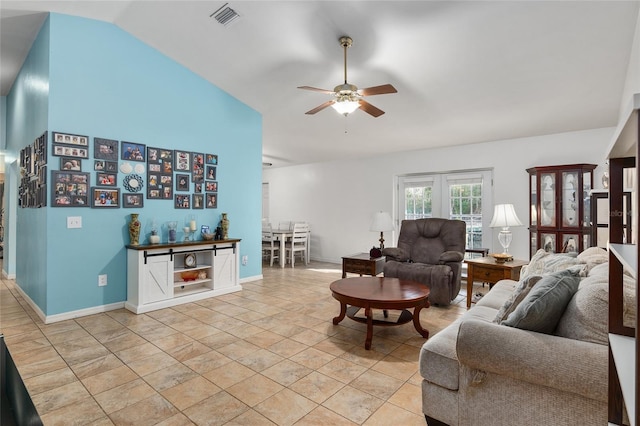 tiled living room featuring ceiling fan, bar, and vaulted ceiling