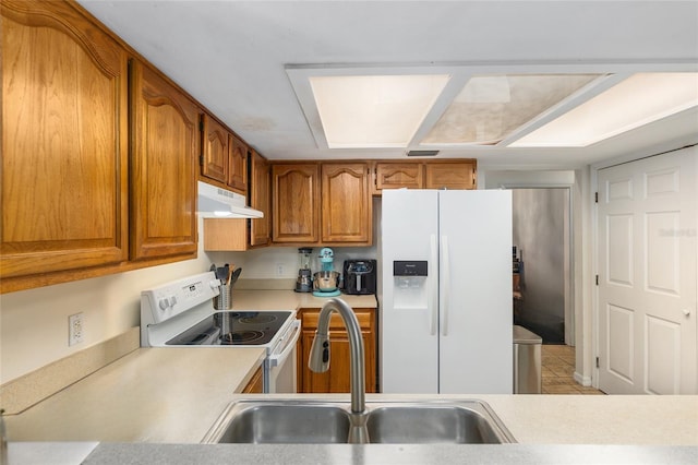 kitchen with sink, white appliances, and light tile patterned floors