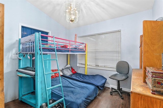 bedroom with dark hardwood / wood-style flooring and a chandelier