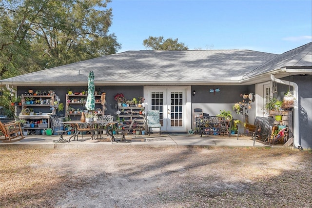 rear view of property with a patio area and french doors