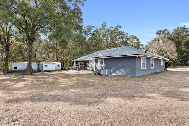 view of property exterior with central AC