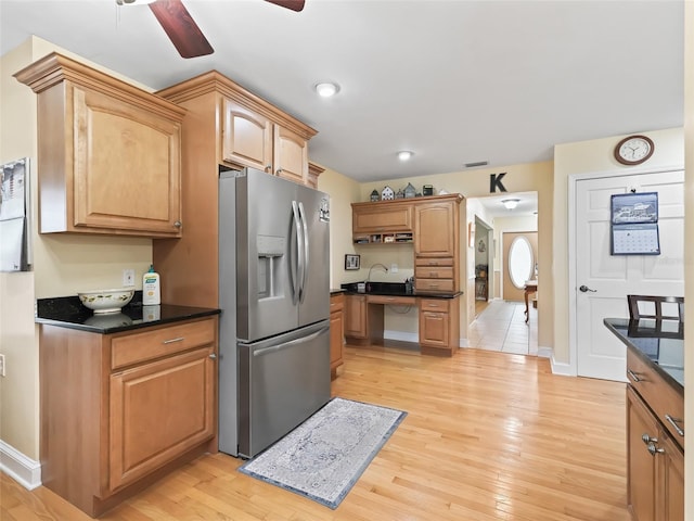 kitchen featuring ceiling fan, stainless steel fridge with ice dispenser, and light wood-type flooring