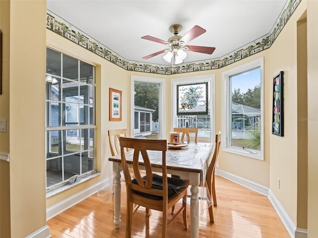 dining space featuring ceiling fan and light wood-type flooring