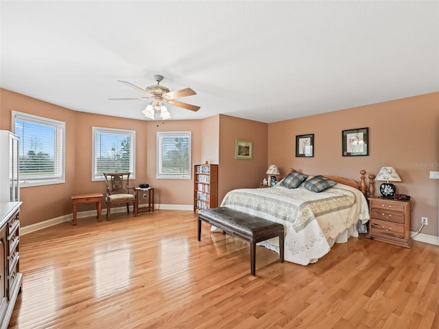 bedroom with multiple windows, ceiling fan, and light wood-type flooring