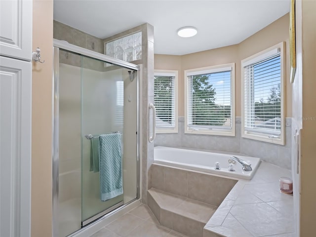 bathroom featuring tile patterned flooring and shower with separate bathtub