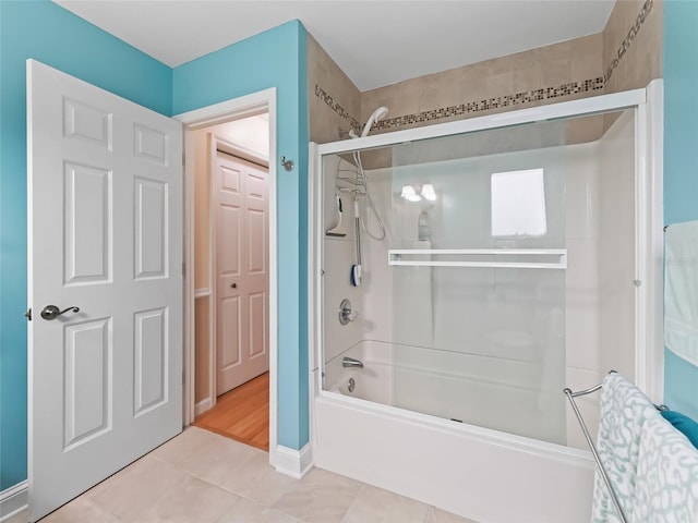 bathroom featuring tile patterned floors and combined bath / shower with glass door