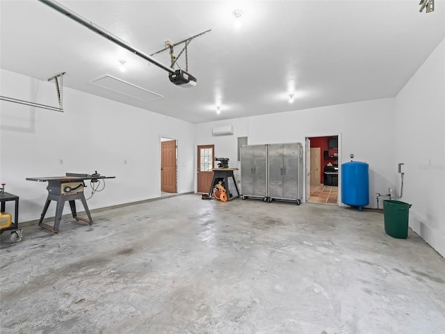 garage with a garage door opener and a wall mounted air conditioner