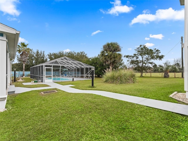 view of yard featuring glass enclosure