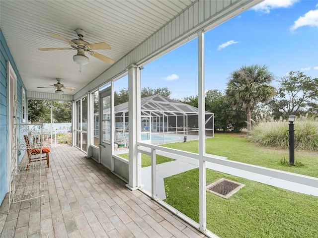 unfurnished sunroom with a healthy amount of sunlight and ceiling fan