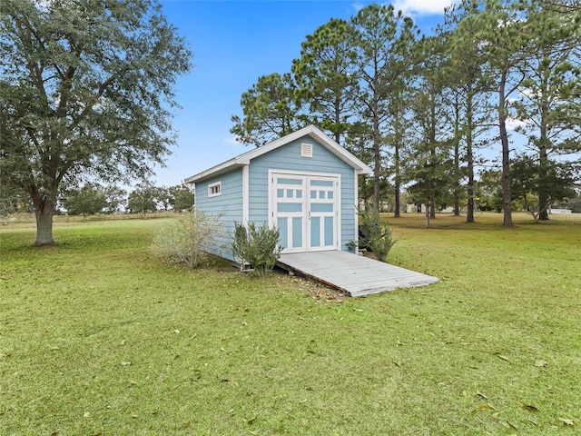 view of outbuilding featuring a yard