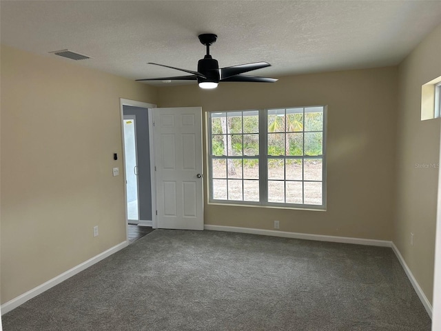 unfurnished room featuring ceiling fan and carpet