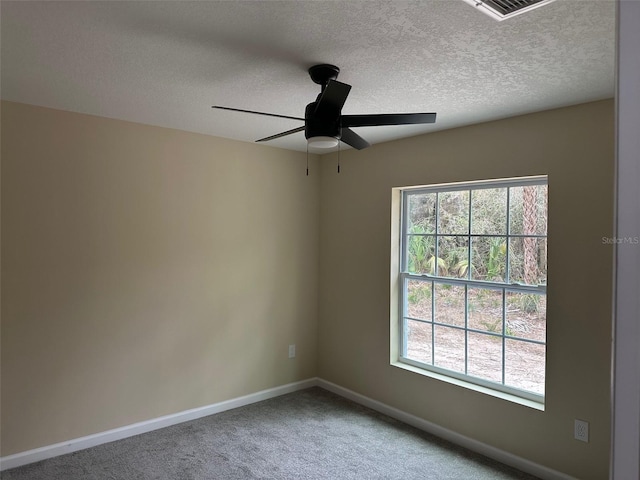 unfurnished room featuring carpet floors, a textured ceiling, plenty of natural light, and ceiling fan