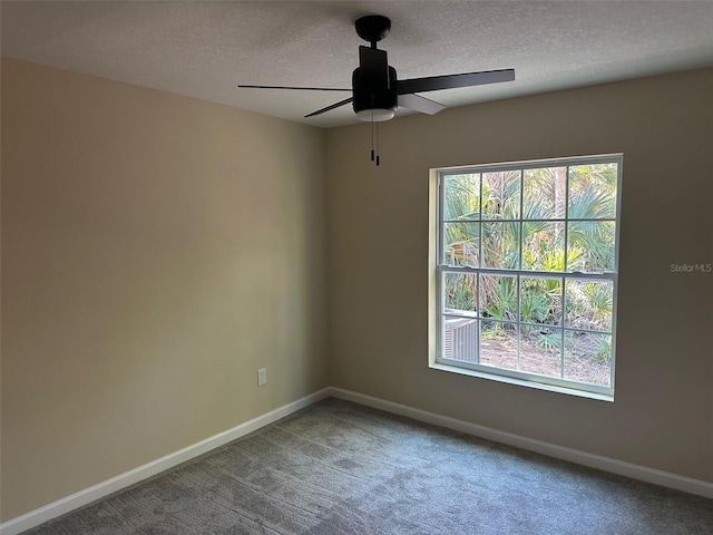 spare room featuring carpet, a textured ceiling, and ceiling fan