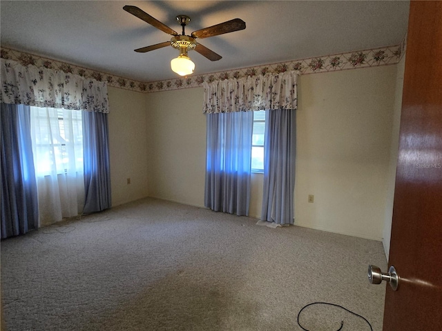 spare room with ceiling fan and carpet floors