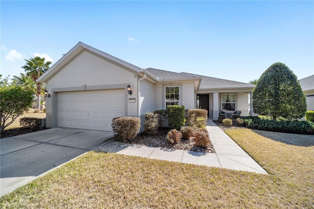 single story home featuring a garage and a front yard