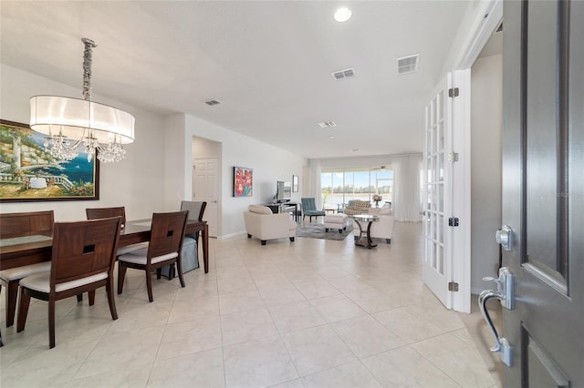 interior space with an inviting chandelier and light tile patterned floors