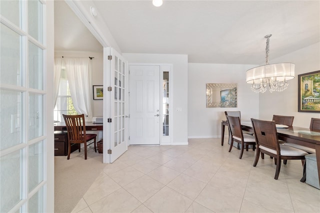 dining space with french doors, light tile patterned floors, and a notable chandelier