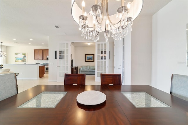 unfurnished dining area featuring french doors and a notable chandelier