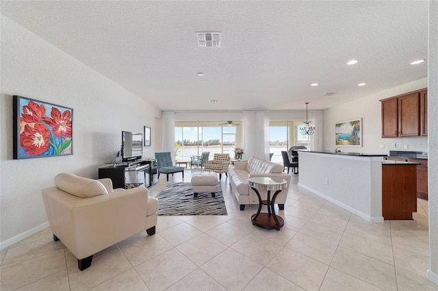 living room with light tile patterned floors and a textured ceiling