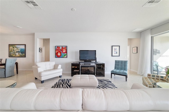 tiled living room with a textured ceiling