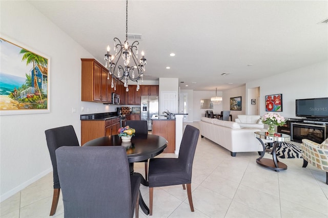 dining room with an inviting chandelier and light tile patterned floors