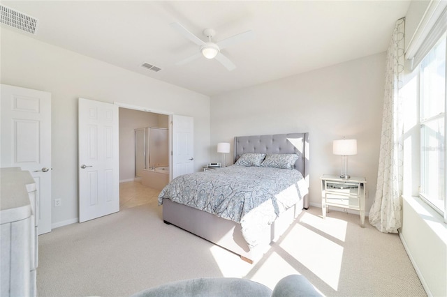 carpeted bedroom with connected bathroom and ceiling fan