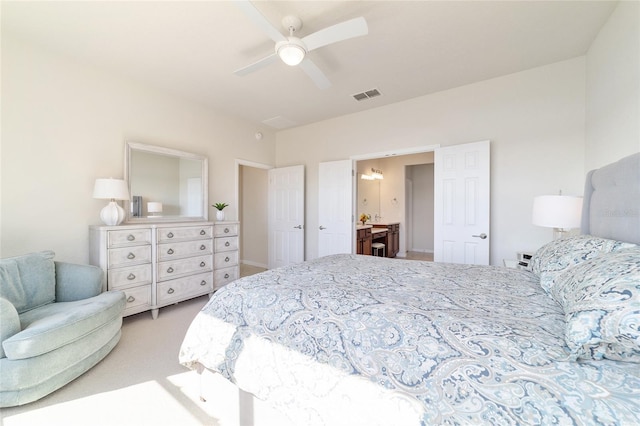 carpeted bedroom featuring ensuite bath and ceiling fan