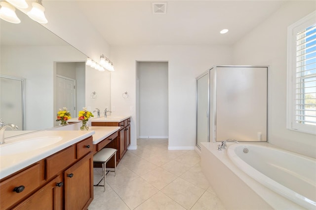 bathroom with tile patterned flooring, vanity, and separate shower and tub