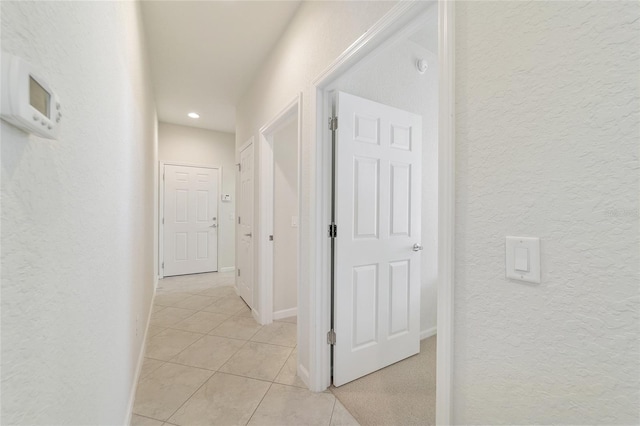 corridor with light tile patterned flooring